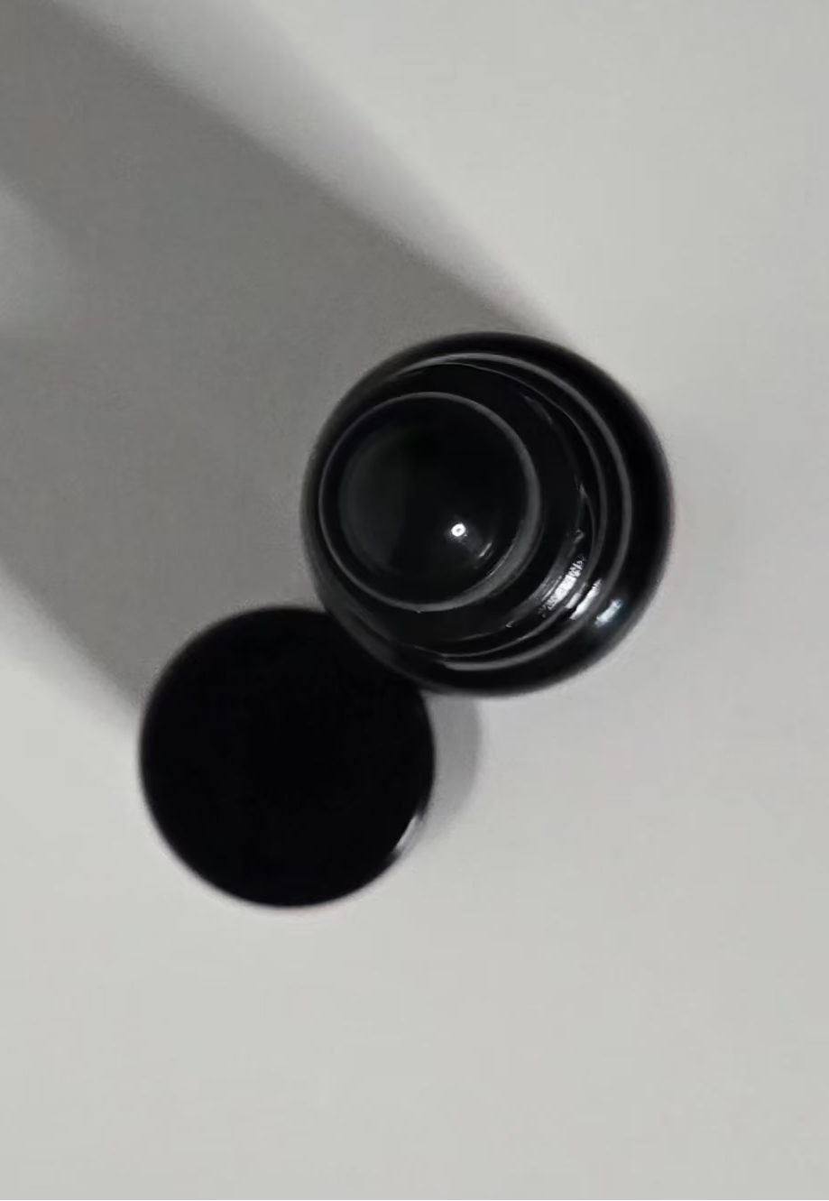 Black cylindrical container on a white background