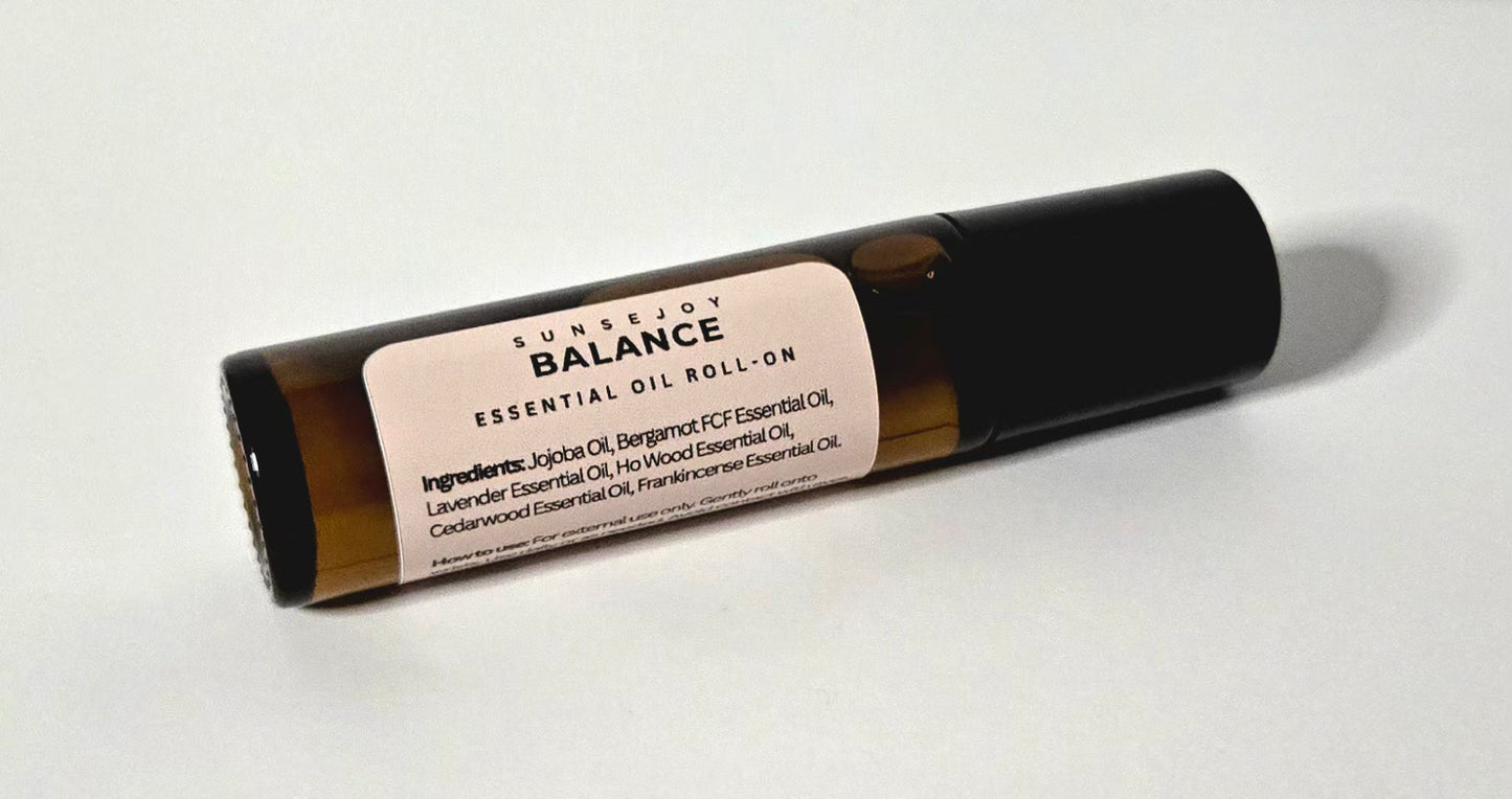 Essential oil roll-on bottle labeled 'Sunsejoy Balance' on a white background