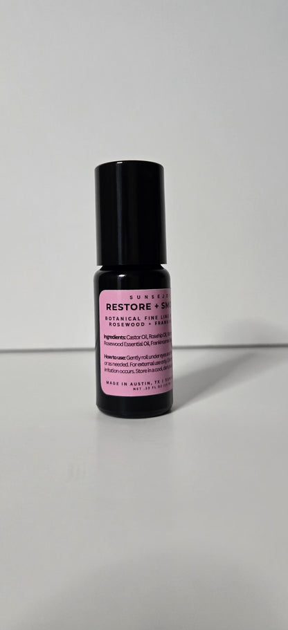 Small black bottle with a pink label on a white background