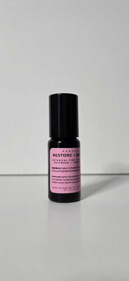 Skincare serum bottle with black cap and purple label on a white background