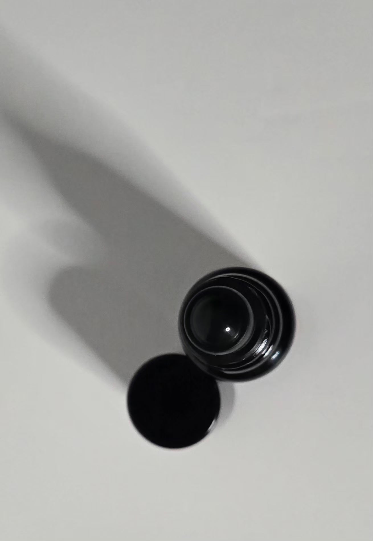 Black cylindrical container on a white background