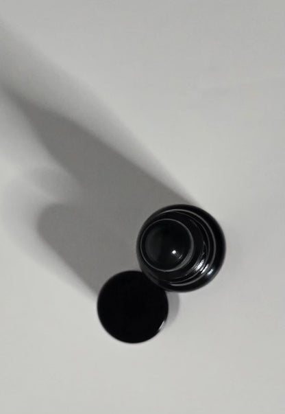 Black cylindrical container on a white background