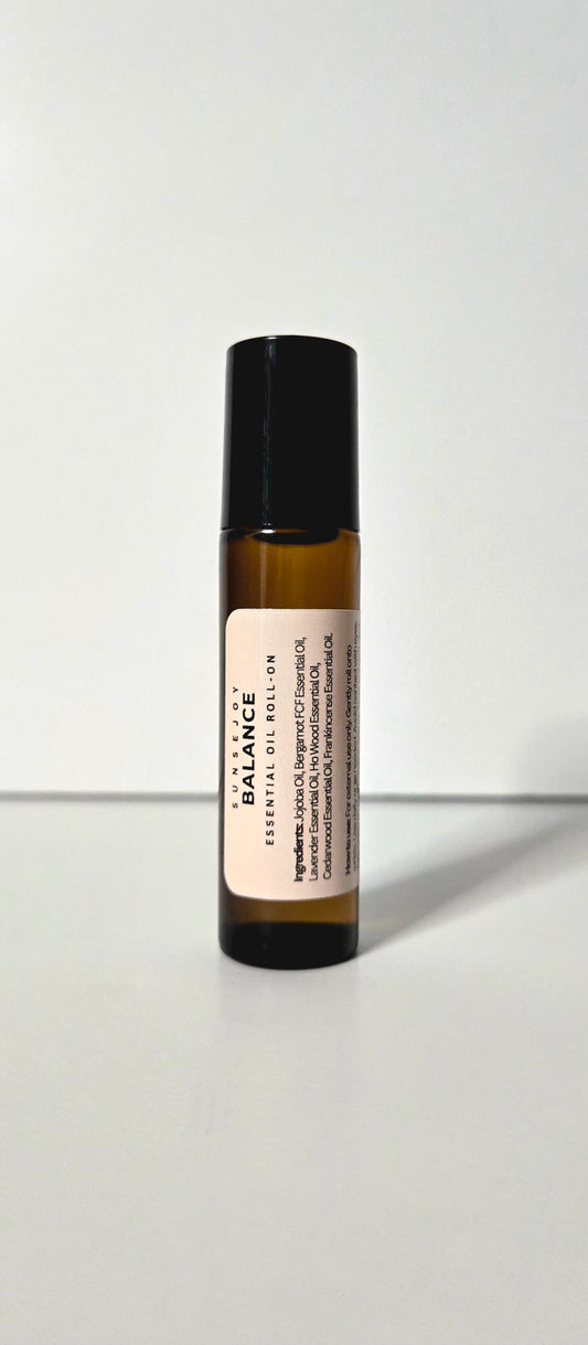 Roll-on bottle of Balance essential oil on a white background
