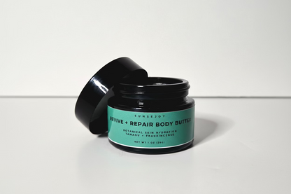 Black jar of 'Revive + Repair Body Butter' with a green label on a white background