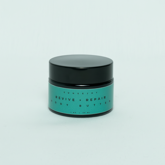 Green jar of 'Revive + Repair' body butter with black lid on a light gray background