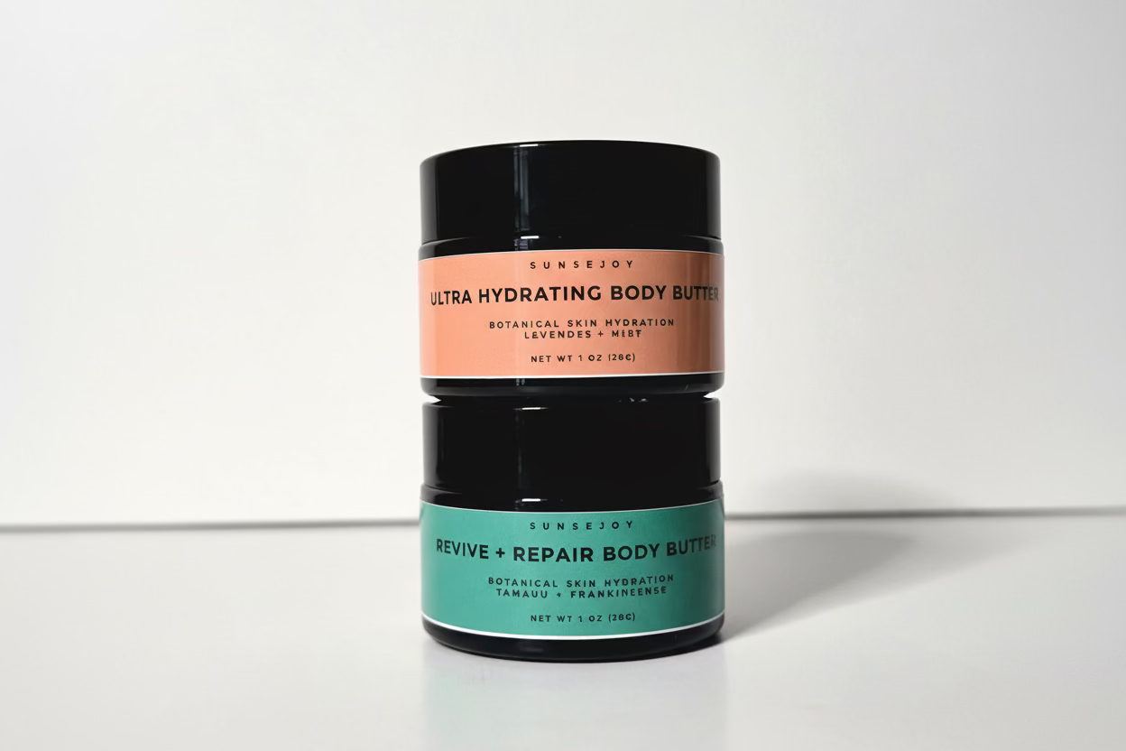 Two cylindrical containers of Ultra Hydrating Body Butter on a white background
