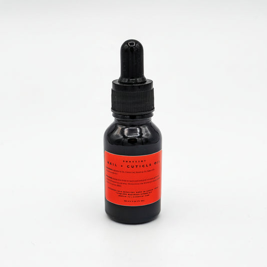 Black Glass Bottle with a red label of cuticle oil with a dropper on a white background