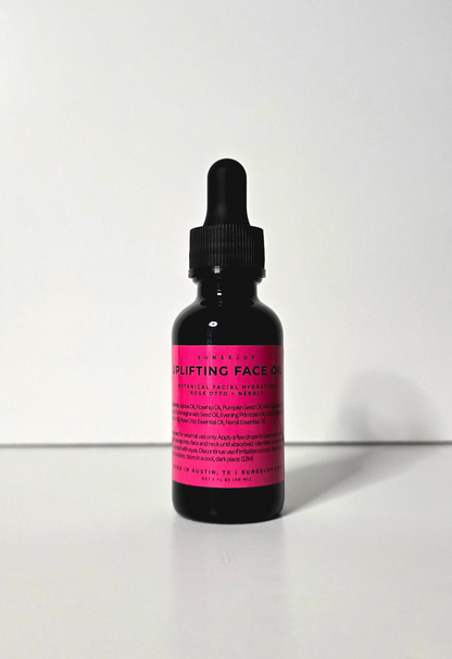Bottle of 'uplifting face oil' with pink label on a white background